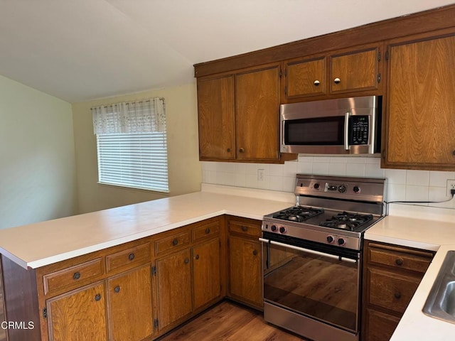 1721 Joliet Pl, Oxnard, CA 93030 - kitchen with stainless steel appliances, a peninsula, light countertops, and decorative backsplash