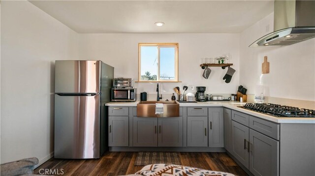 61748 Valley View Cir, Joshua Tree, CA 92252 - kitchen with stainless steel appliances, wall chimney exhaust hood, gray cabinets, a sink, and light countertops