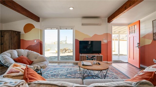 61748 Valley View Cir, Joshua Tree, CA 92252 - living room featuring an AC wall unit, beamed ceiling, wood finished floors, plenty of natural light, and baseboards