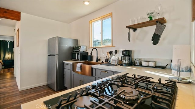 61748 Valley View Cir, Joshua Tree, CA 92252 - kitchen with freestanding refrigerator, a sink, black microwave, wood finished floors, and open shelves