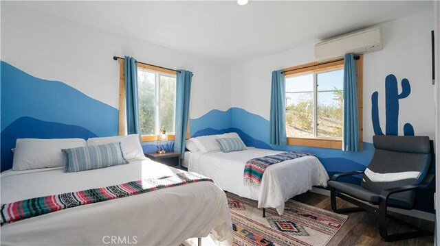 61748 Valley View Cir, Joshua Tree, CA 92252 - bedroom with a wall mounted AC, wood finished floors, and recessed lighting