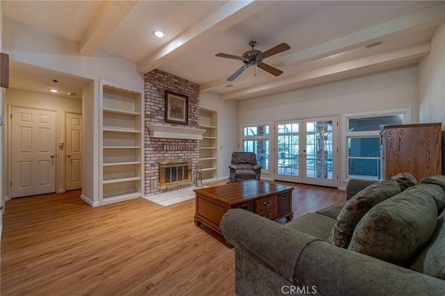 2020 Station Ave, Atwater, CA 95301 - living area with french doors, beam ceiling, wood finished floors, ceiling fan, and a brick fireplace