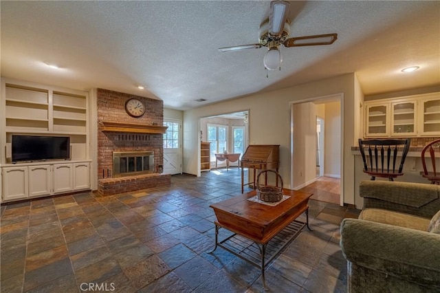 2020 Station Ave, Atwater, CA 95301 - living area with a ceiling fan, a textured ceiling, a fireplace, baseboards, and built in features