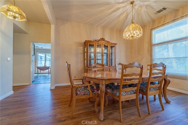 2020 Station Ave, Atwater, CA 95301 - dining room with a chandelier, wood finished floors, and baseboards