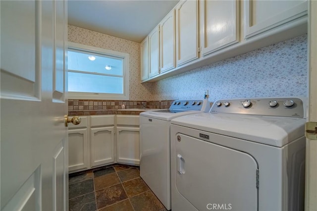2020 Station Ave, Atwater, CA 95301 - washroom featuring washing machine and clothes dryer, cabinet space, wallpapered walls, and dark stone finish flooring
