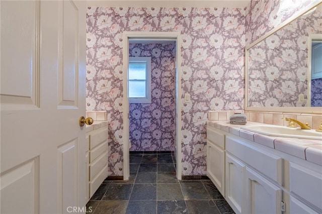 2020 Station Ave, Atwater, CA 95301 - bathroom featuring wallpapered walls, vanity, baseboards, and stone finish floors