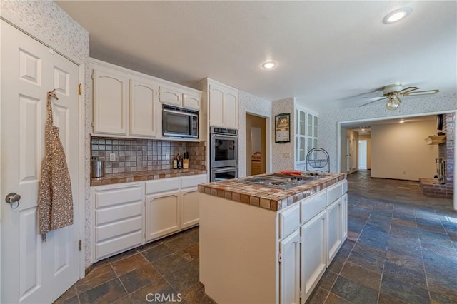 2020 Station Ave, Atwater, CA 95301 - kitchen featuring stainless steel appliances, tile counters, stone tile floors, white cabinetry, and recessed lighting