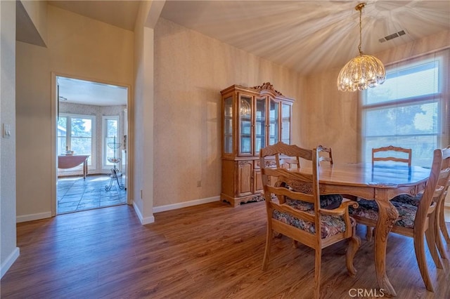 2020 Station Ave, Atwater, CA 95301 - dining area featuring a chandelier, wood finished floors, and baseboards