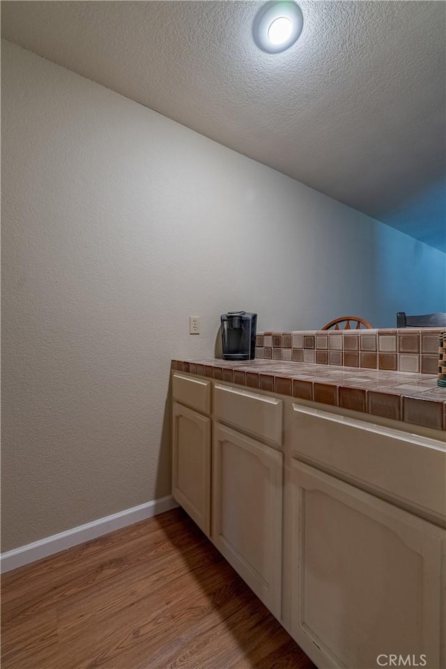 2020 Station Ave, Atwater, CA 95301 - bar area with light wood finished floors, baseboards, and a textured ceiling