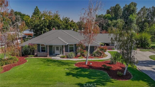 2020 Station Ave, Atwater, CA 95301 - view of front of home featuring a front yard, a chimney, and concrete driveway