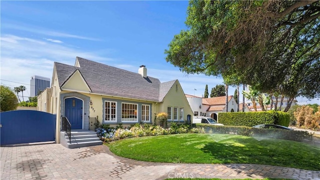 827 Hauser Blvd, Los Angeles, CA 90036 - english style home with stucco siding, a front yard, a chimney, and a gate