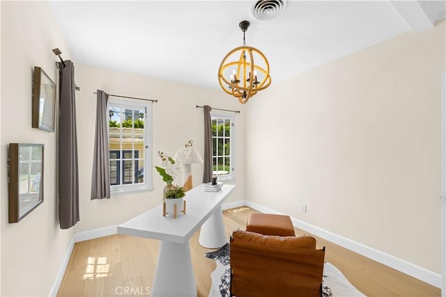 827 Hauser Blvd, Los Angeles, CA 90036 - dining area featuring a chandelier, wood finished floors, and baseboards