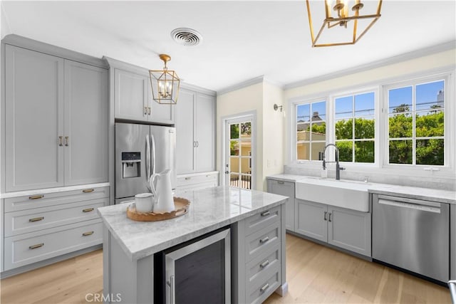 827 Hauser Blvd, Los Angeles, CA 90036 - kitchen with stainless steel appliances, a chandelier, beverage cooler, gray cabinets, and crown molding