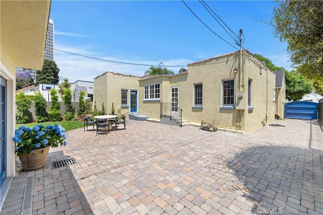 827 Hauser Blvd, Los Angeles, CA 90036 - rear view of house with stucco siding, a patio, and entry steps