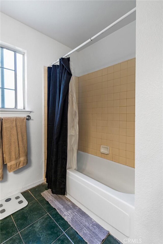 3576 San Jose Ave, Merced, CA 95348 - bathroom featuring shower / tub combo with curtain and tile patterned flooring
