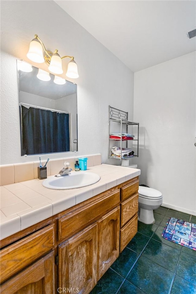 3576 San Jose Ave, Merced, CA 95348 - full bathroom with vanity, toilet, tile patterned flooring, and a shower with shower curtain