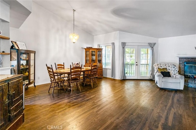 3576 San Jose Ave, Merced, CA 95348 - dining area with wood finished floors, vaulted ceiling, a brick fireplace, baseboards, and french doors
