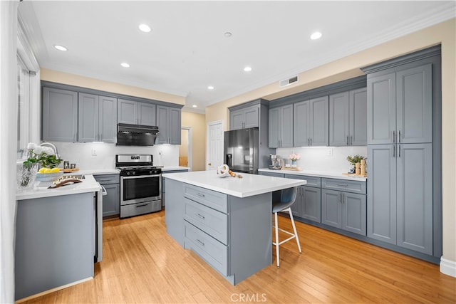 2 Corte Arbertura, San Clemente, CA 92673 - kitchen with stainless steel range with gas cooktop, fridge with ice dispenser, gray cabinets, a center island, and ornamental molding