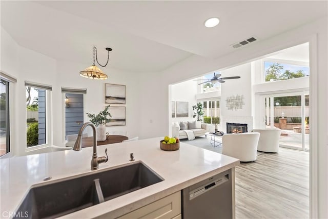 21592 Fernbrook Unit 195, Mission Viejo, CA 92692 - kitchen with a sink, stainless steel dishwasher, light countertops, hanging light fixtures, and a ceiling fan