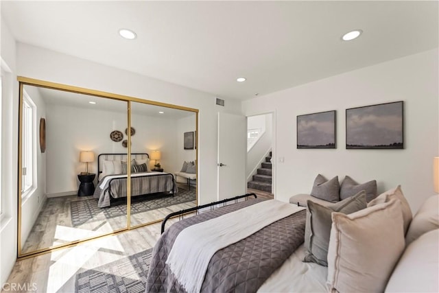 21592 Fernbrook Unit 195, Mission Viejo, CA 92692 - bedroom with recessed lighting, light wood-style flooring, a closet, and multiple windows