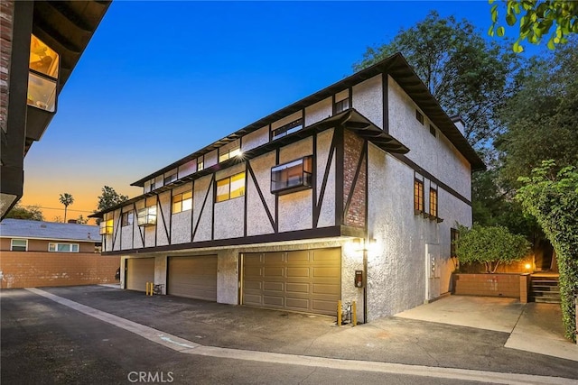 402 El Centro St Unit 13, South Pasadena, CA 91030 - view of side of home with stucco siding, a garage, and driveway