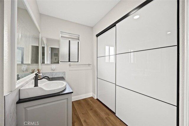 402 El Centro St Unit 13, South Pasadena, CA 91030 - bathroom with baseboards, vanity, and wood finished floors