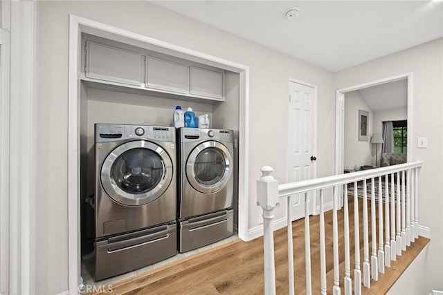 402 El Centro St Unit 13, South Pasadena, CA 91030 - washroom with washing machine and dryer, light wood finished floors, and baseboards