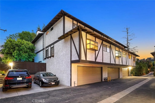402 El Centro St Unit 13, South Pasadena, CA 91030 - view of side of home with stucco siding, an attached garage, and driveway