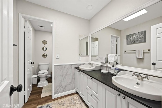 402 El Centro St Unit 13, South Pasadena, CA 91030 - full bathroom featuring double vanity, toilet, tile walls, wood finished floors, and a wainscoted wall