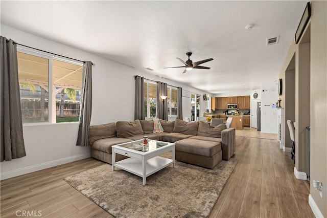 28867 Glencoe Ln, Menifee, CA 92584 - living room with a ceiling fan, light wood-type flooring, and baseboards