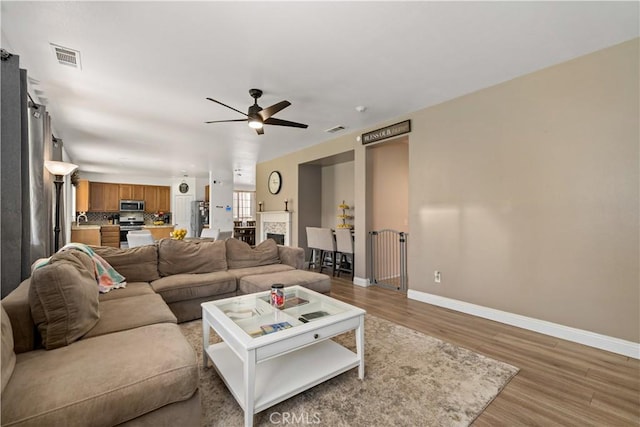 28867 Glencoe Ln, Menifee, CA 92584 - living area featuring baseboards, light wood-style flooring, and a ceiling fan