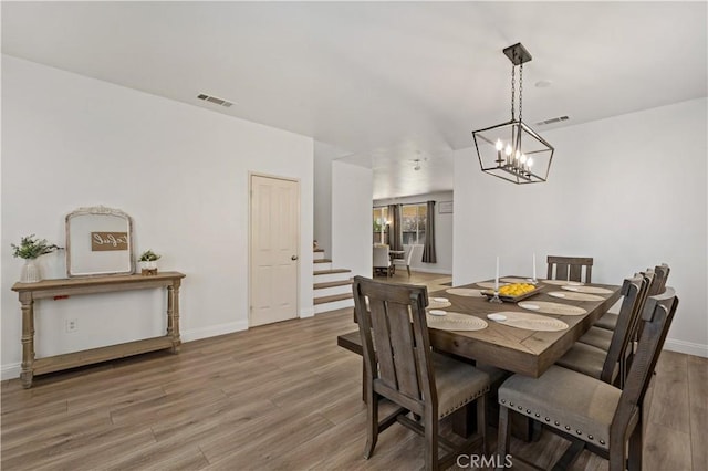 28867 Glencoe Ln, Menifee, CA 92584 - dining room with stairway, wood finished floors, a chandelier, and baseboards