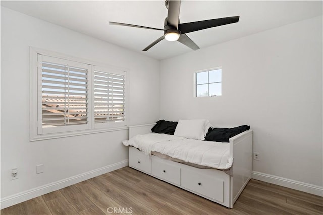 28867 Glencoe Ln, Menifee, CA 92584 - bedroom featuring light wood finished floors, baseboards, and a ceiling fan