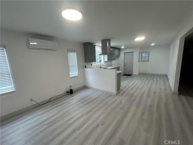 4300 Bancroft Dr, La Mesa, CA 91941 - unfurnished living room featuring a wall unit AC, a sink, baseboards, and light wood-style flooring
