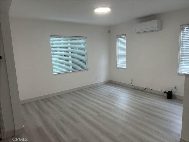 4300 Bancroft Dr, La Mesa, CA 91941 - spare room with an AC wall unit, light wood finished floors, and baseboards