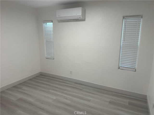 4300 Bancroft Dr, La Mesa, CA 91941 - empty room with a wall mounted AC, wood finished floors, and baseboards