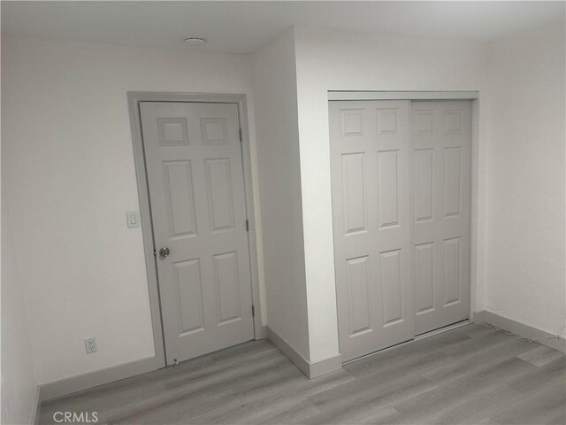 4300 Bancroft Dr, La Mesa, CA 91941 - unfurnished bedroom with light wood finished floors, baseboards, and a closet