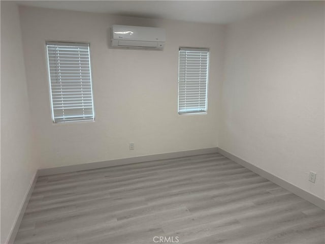 4300 Bancroft Dr, La Mesa, CA 91941 - empty room with a wall mounted air conditioner, wood finished floors, and baseboards