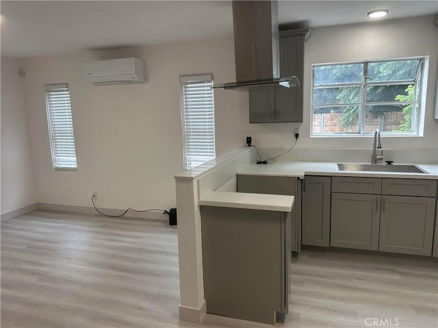 4300 Bancroft Dr, La Mesa, CA 91941 - kitchen with a sink, gray cabinets, island exhaust hood, and a wall unit AC