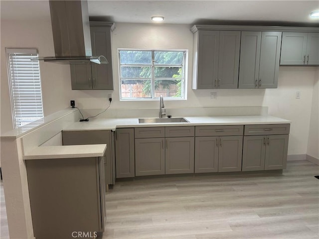 4300 Bancroft Dr, La Mesa, CA 91941 - kitchen with a sink, exhaust hood, light wood-style flooring, gray cabinetry, and light countertops