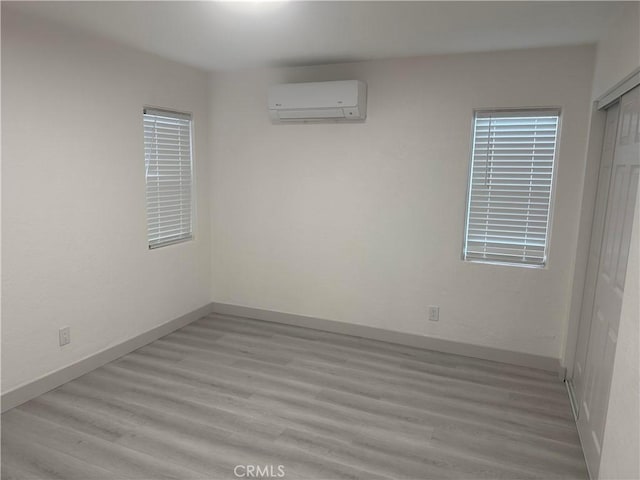 4300 Bancroft Dr, La Mesa, CA 91941 - spare room with an AC wall unit, light wood finished floors, and baseboards