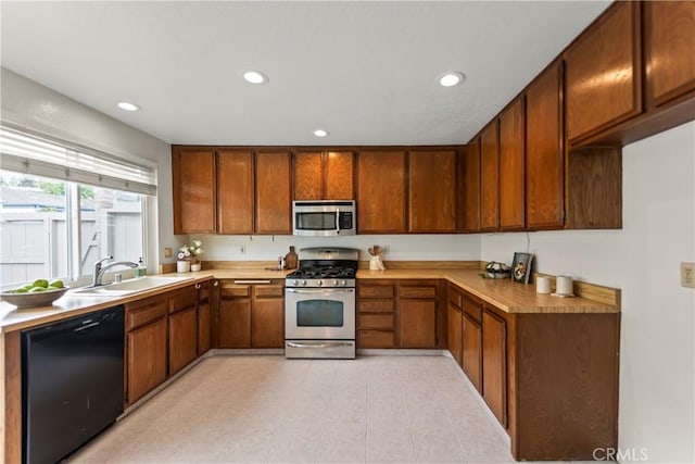 22972 Caminito Linda, Laguna Hills, CA 92653 - kitchen featuring stainless steel appliances, a sink, recessed lighting, light countertops, and brown cabinets