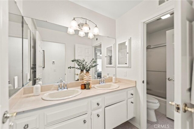 22972 Caminito Linda, Laguna Hills, CA 92653 - full bath with double vanity, tile patterned flooring, toilet, and enclosed tub / shower combo