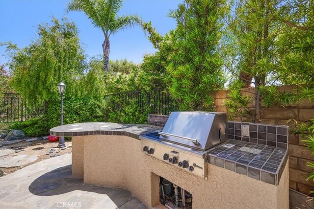 20333 Wynfreed Ln, Porter Ranch, CA 91326 - fenced backyard with an outdoor kitchen