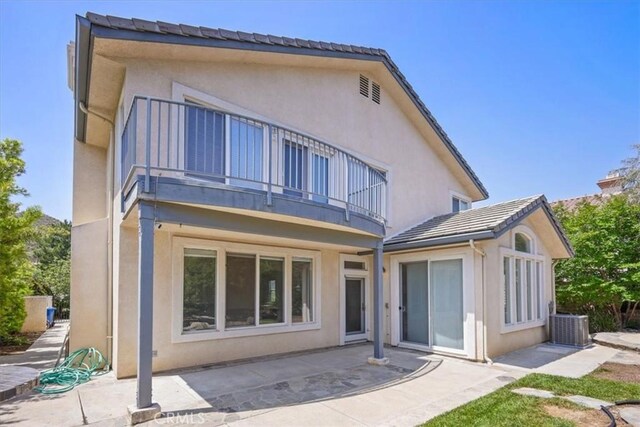 20333 Wynfreed Ln, Porter Ranch, CA 91326 - rear view of house featuring a balcony, stucco siding, and a patio area