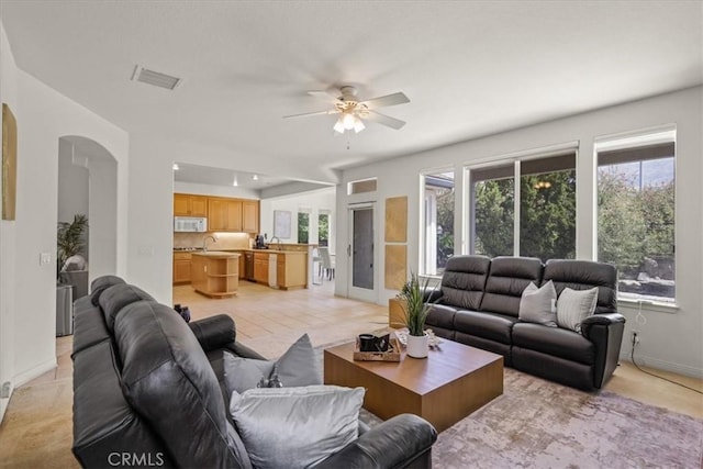 20333 Wynfreed Ln, Porter Ranch, CA 91326 - living room featuring arched walkways, ceiling fan, and baseboards