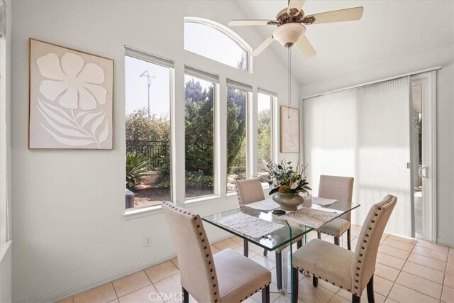 20333 Wynfreed Ln, Porter Ranch, CA 91326 - dining space featuring light tile patterned floors, lofted ceiling, ceiling fan, and baseboards