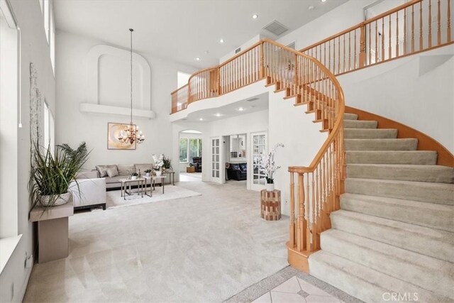 20333 Wynfreed Ln, Porter Ranch, CA 91326 - living area featuring a high ceiling, stairway, recessed lighting, french doors, and carpet floors