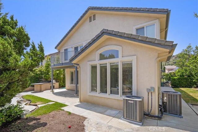 20333 Wynfreed Ln, Porter Ranch, CA 91326 - back of property with a balcony, cooling unit, stucco siding, and a hot tub