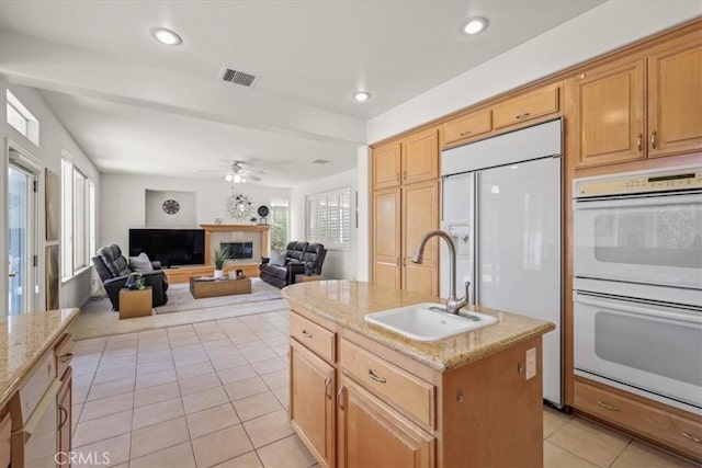 20333 Wynfreed Ln, Porter Ranch, CA 91326 - kitchen with double oven, a sink, paneled fridge, light tile patterned floors, and a center island with sink
